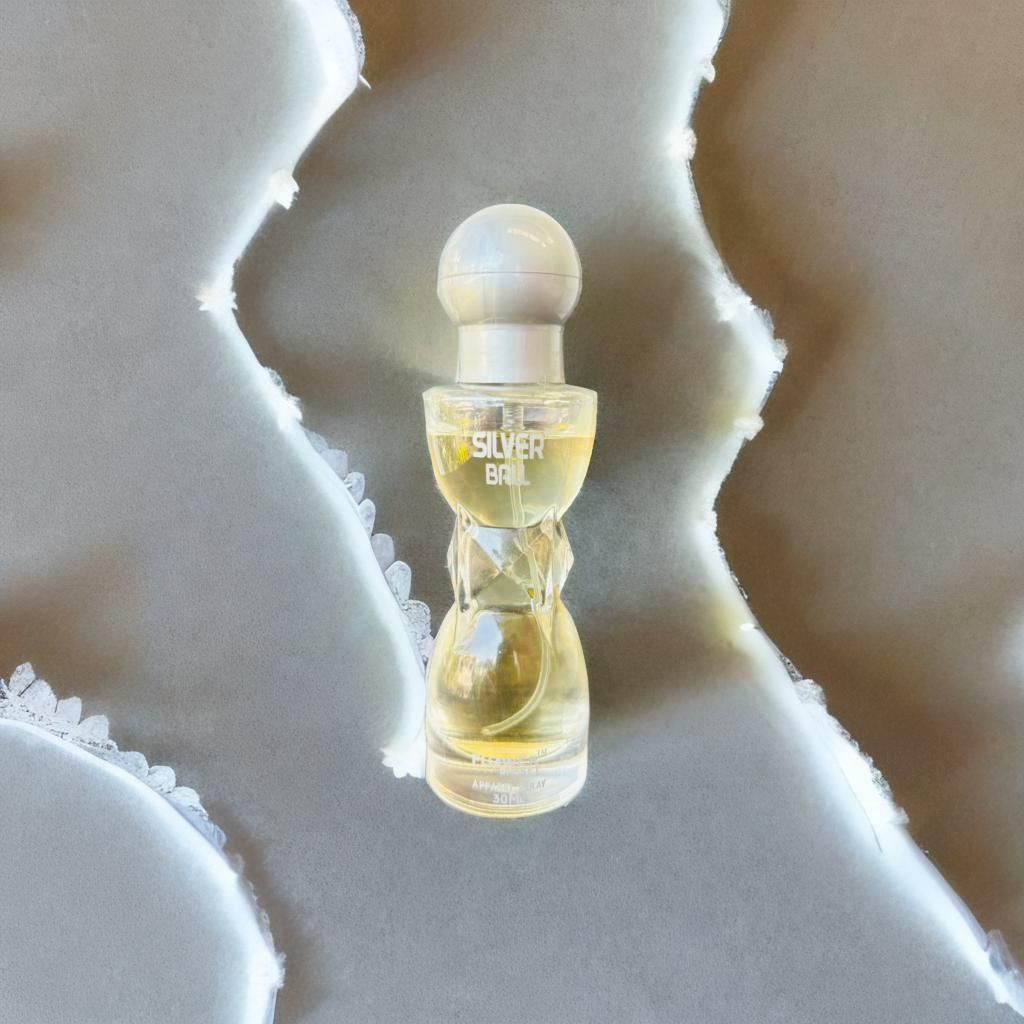 Perfume bottle labeled 'Silver Ball' on a textured white surface