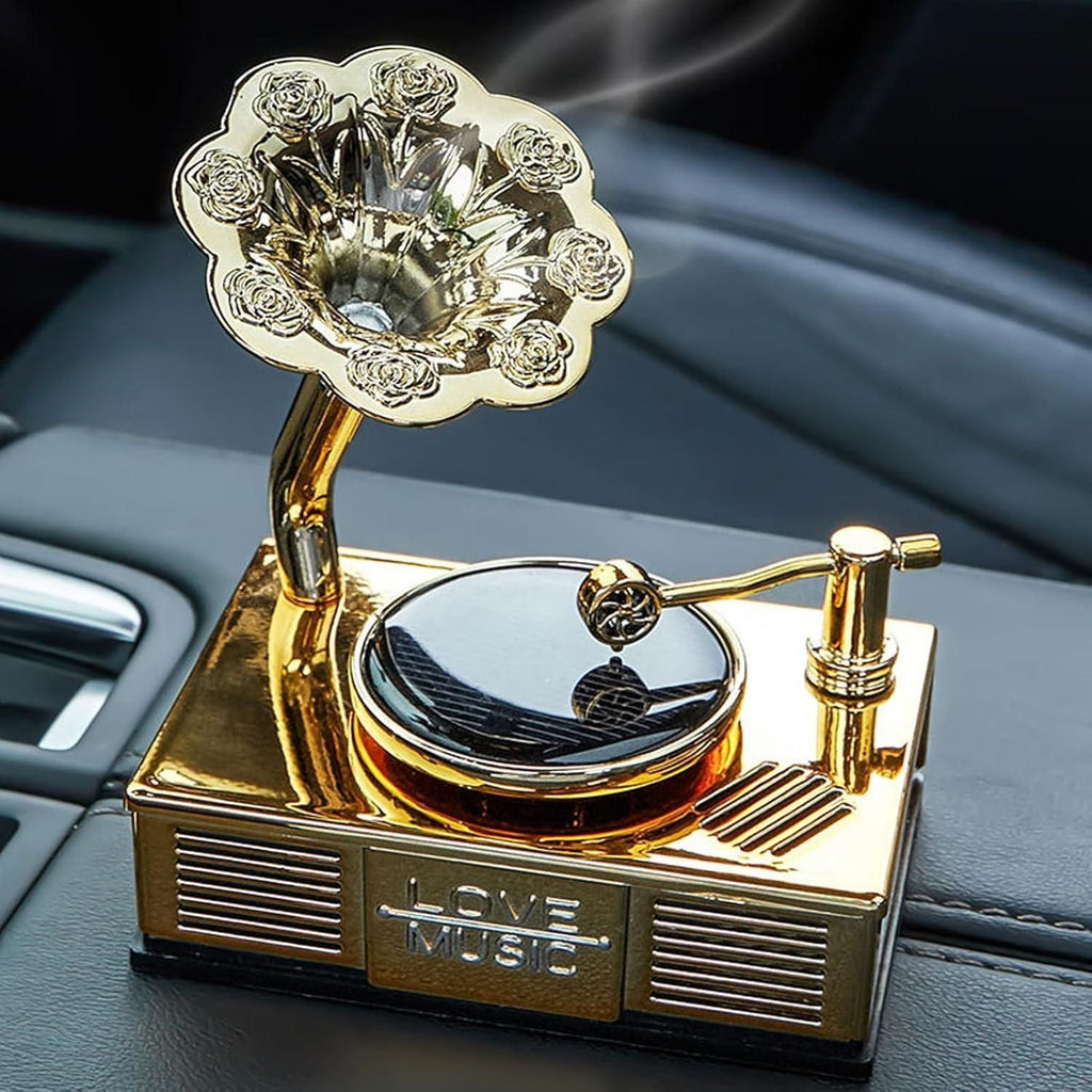 Decorative gold gramophone on a car dashboard with 'Love Music' text.