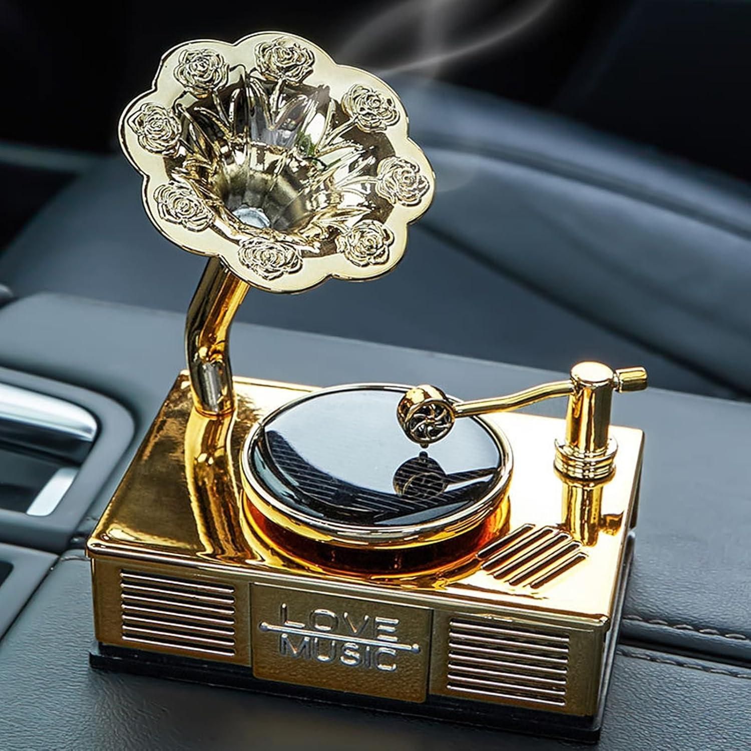 Decorative gold gramophone on a car dashboard with 'Love Music' text.